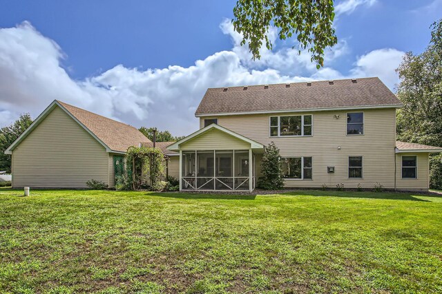 18046 Zodiac St NE, Columbus, MN 55025 - rear view of house featuring a sunroom, a lawn, and a shingled roof