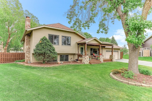14308 Park Ave, Burnsville, MN 55337 - split level home with a chimney, an attached garage, a porch, and concrete driveway