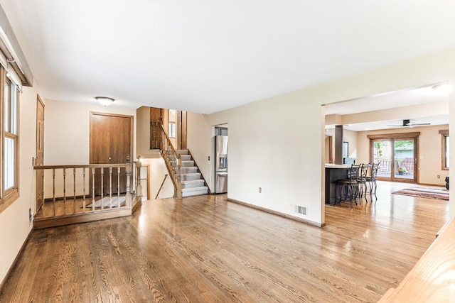 14308 Park Ave, Burnsville, MN 55337 - empty room with wood finished floors, stairway, ceiling fan, and baseboards