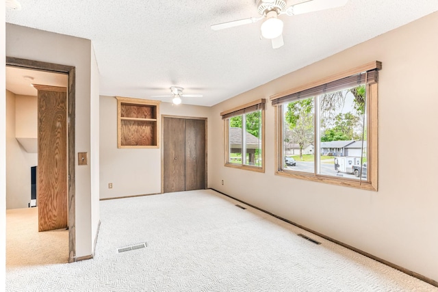 14308 Park Ave, Burnsville, MN 55337 - unfurnished room featuring a ceiling fan, carpet flooring, baseboards, and a textured ceiling