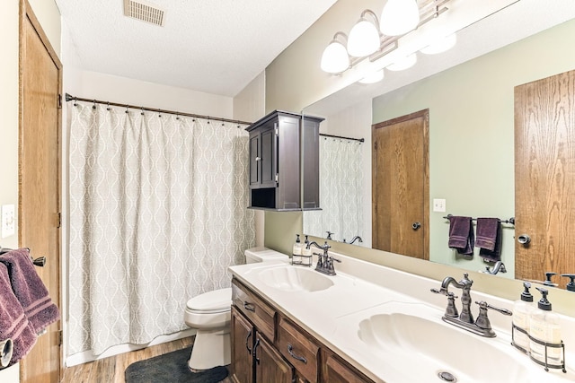 14308 Park Ave, Burnsville, MN 55337 - bathroom with toilet, wood finished floors, double vanity, and a shower with shower curtain