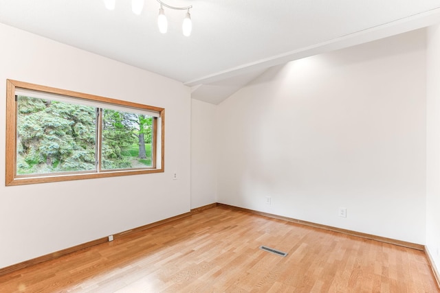 14308 Park Ave, Burnsville, MN 55337 - empty room featuring light wood-style floors, baseboards, and lofted ceiling