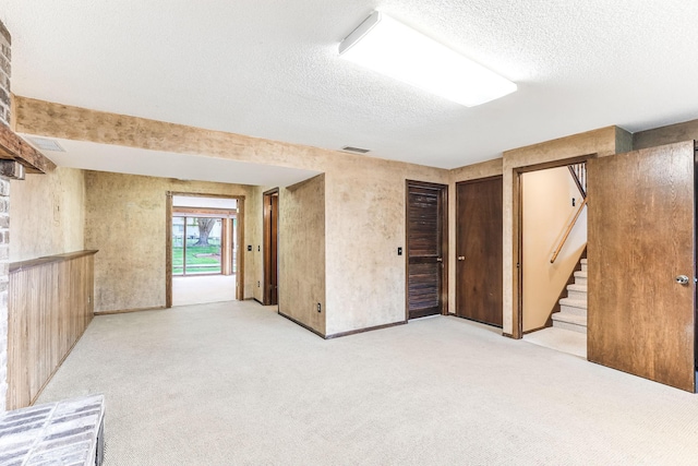 14308 Park Ave, Burnsville, MN 55337 - basement with a textured ceiling, light carpet, and stairway