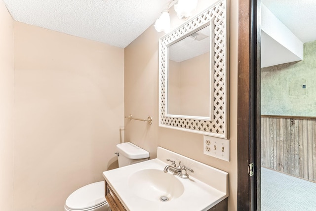 14308 Park Ave, Burnsville, MN 55337 - half bathroom featuring toilet, a textured ceiling, and vanity