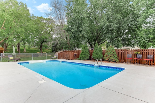 14308 Park Ave, Burnsville, MN 55337 - view of pool with a patio area, fence, and view of scattered trees