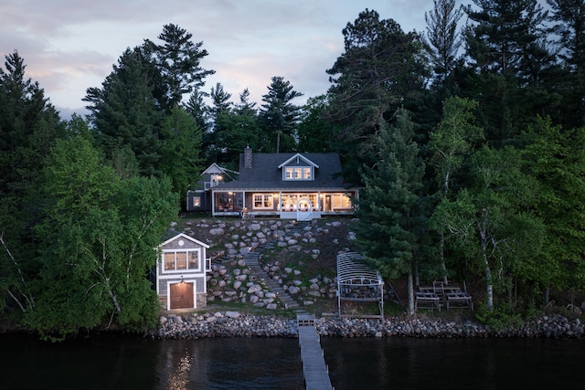 6024 Ojibwa Rd, Brainerd, MN 56401 - view of front of property with a chimney and a deck with water view