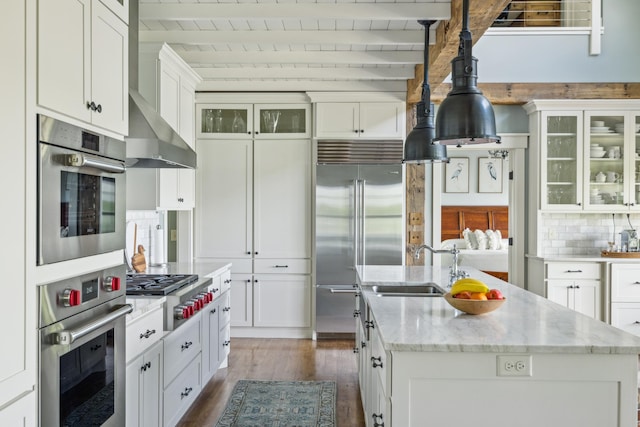 6024 Ojibwa Rd, Brainerd, MN 56401 - kitchen featuring stainless steel appliances, dark wood-style floors, a sink, a center island with sink, and white cabinets