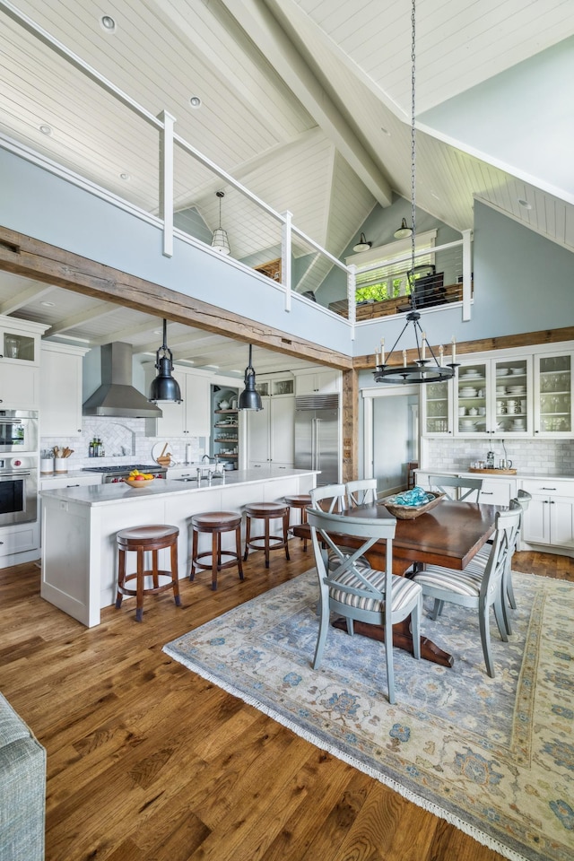 6024 Ojibwa Rd, Brainerd, MN 56401 - dining area with high vaulted ceiling, wood finished floors, and wooden ceiling with exposed beams