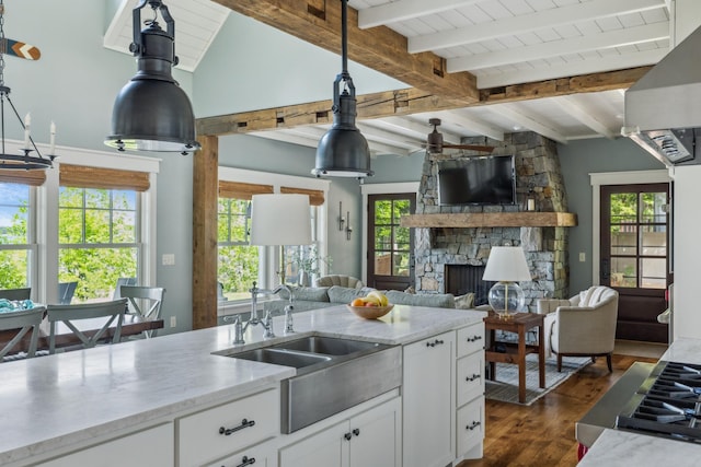 6024 Ojibwa Rd, Brainerd, MN 56401 - kitchen featuring a stone fireplace, dark wood-type flooring, white cabinets, healthy amount of natural light, and wooden ceiling