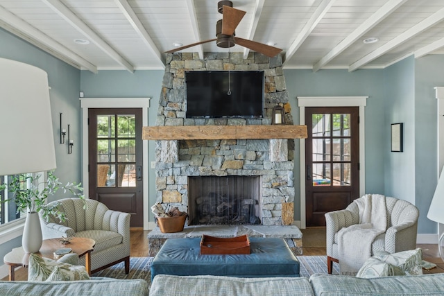 6024 Ojibwa Rd, Brainerd, MN 56401 - living room featuring wood finished floors, a fireplace, ceiling fan, and baseboards
