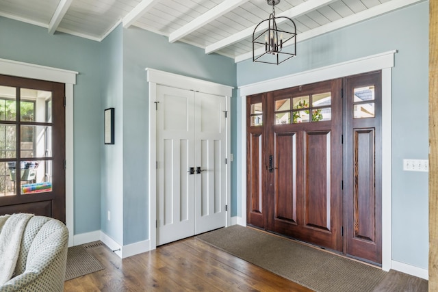 6024 Ojibwa Rd, Brainerd, MN 56401 - foyer with baseboards, dark wood-style floors, a chandelier, and beam ceiling