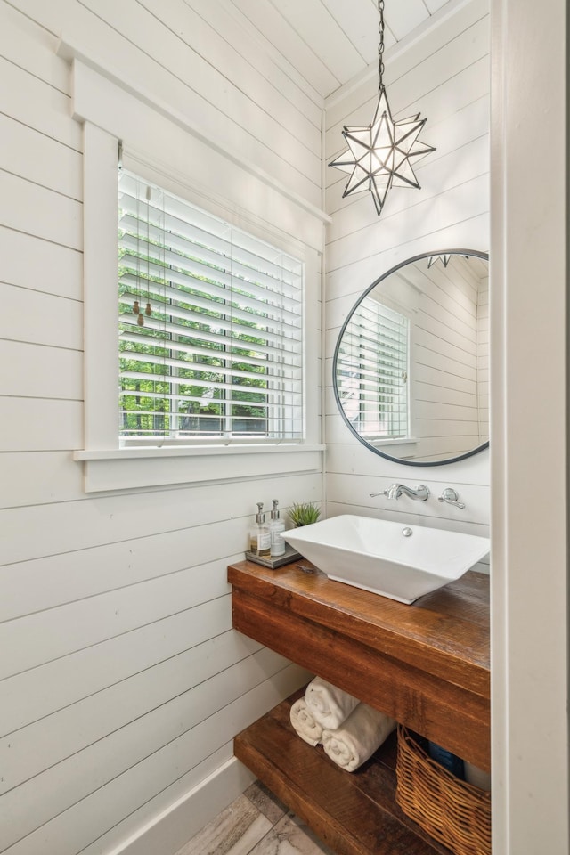 6024 Ojibwa Rd, Brainerd, MN 56401 - bathroom featuring wood walls and a sink