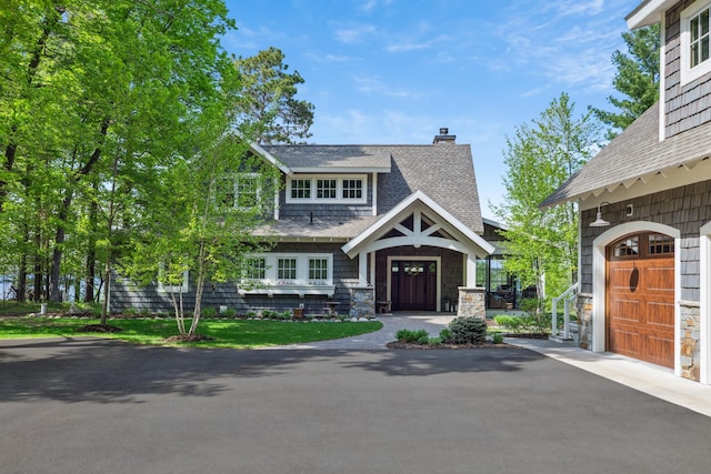 6024 Ojibwa Rd, Brainerd, MN 56401 - view of front of house with a chimney, a shingled roof, and stone siding