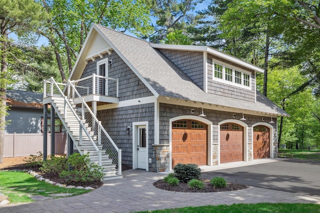 6024 Ojibwa Rd, Brainerd, MN 56401 - view of front of home with roof with shingles, stairway, a garage, and asphalt driveway