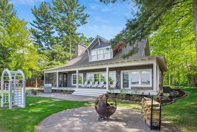 6024 Ojibwa Rd, Brainerd, MN 56401 - rear view of house with a patio area, a chimney, and roof with shingles