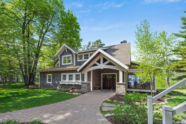 6024 Ojibwa Rd, Brainerd, MN 56401 - view of front of house featuring a front yard, a chimney, a shingled roof, and a porch