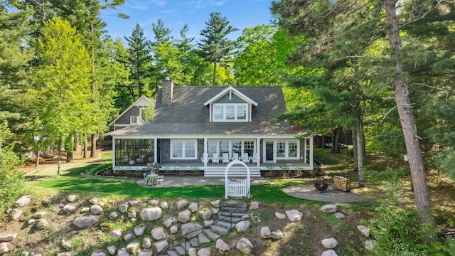 6024 Ojibwa Rd, Brainerd, MN 56401 - view of front of house with a chimney and a front lawn