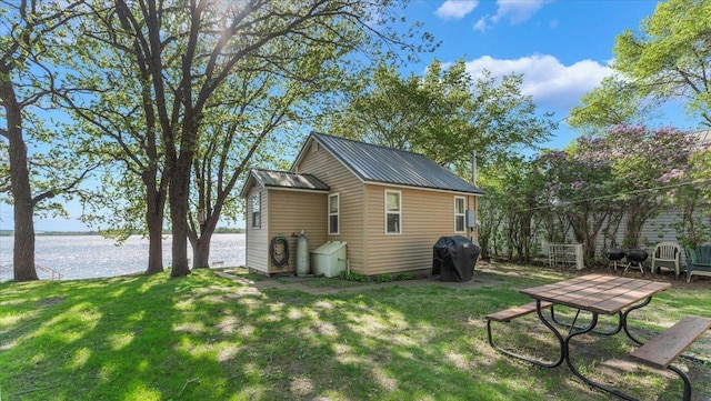 13749 169th Ave, Villard, MN 56385 - view of home's exterior featuring a water view, a yard, and metal roof