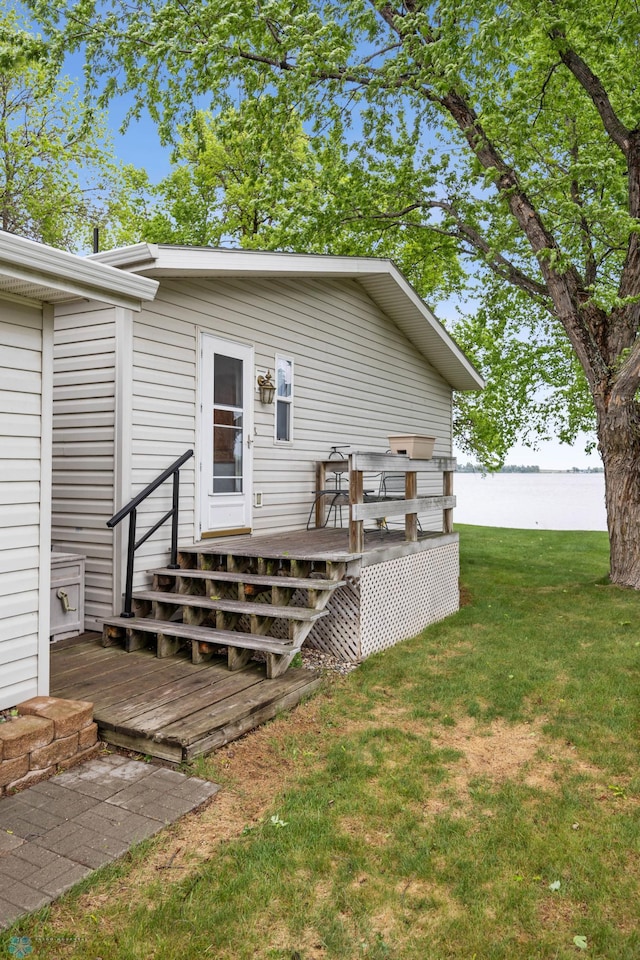 45642 Devils Lake Rd, Edna Twp, MN 56573 - rear view of property featuring a deck with water view and a yard