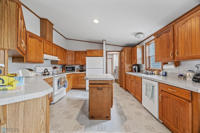 45642 Devils Lake Rd, Edna Twp, MN 56573 - kitchen with white appliances, under cabinet range hood, lofted ceiling, light floors, and light countertops