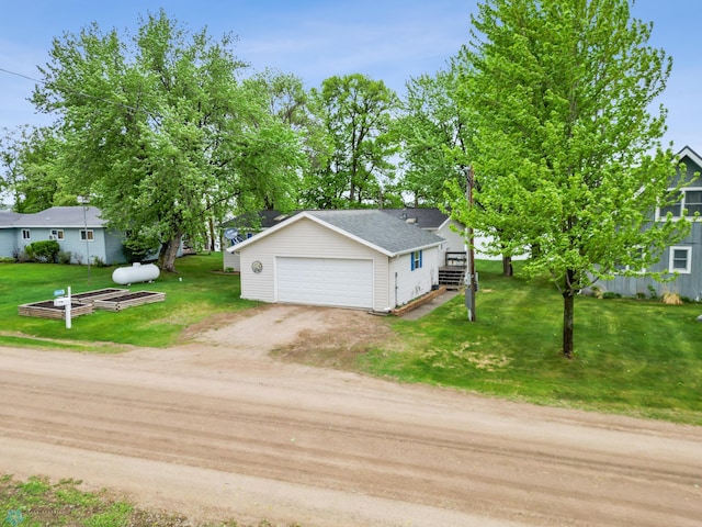 45642 Devils Lake Rd, Edna Twp, MN 56573 - view of front facade featuring a front yard, a detached garage, driveway, and a shingled roof