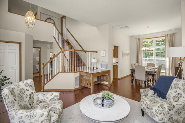4132 Oakbrooke Curv, Eagan, MN 55122 - living area with a chandelier, stairs, wood finished floors, and baseboards