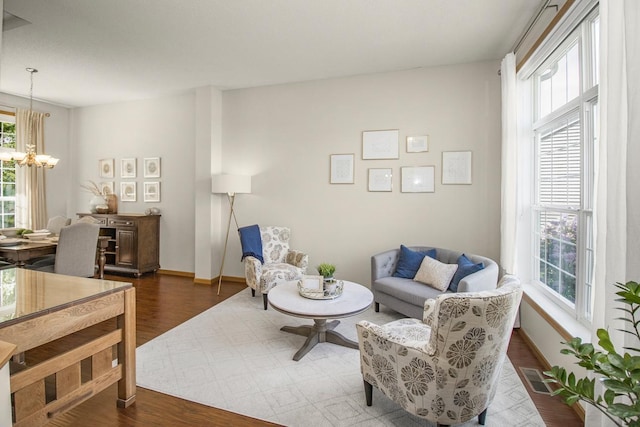 4132 Oakbrooke Curv, Eagan, MN 55122 - living room featuring a chandelier, dark wood-style floors, and baseboards