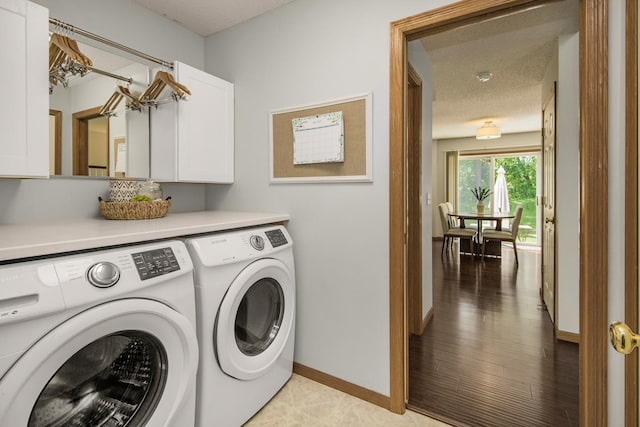 4132 Oakbrooke Curv, Eagan, MN 55122 - laundry area featuring cabinet space, washer and dryer, baseboards, and a textured ceiling