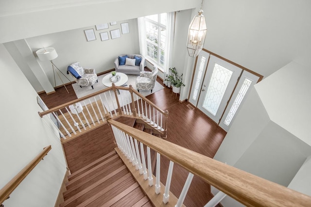4132 Oakbrooke Curv, Eagan, MN 55122 - staircase with wood finished floors, a chandelier, and a towering ceiling