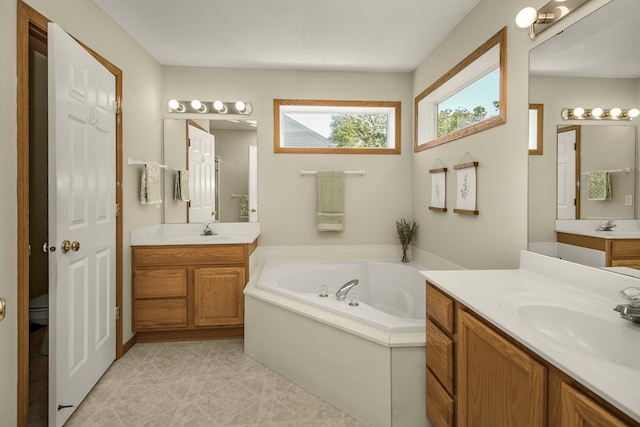 4132 Oakbrooke Curv, Eagan, MN 55122 - bathroom featuring two vanities and a garden tub