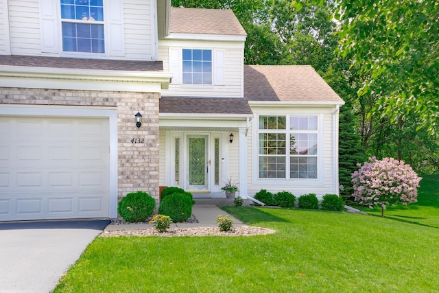 4132 Oakbrooke Curv, Eagan, MN 55122 - view of front of home featuring a front lawn, a shingled roof, driveway, stone siding, and an attached garage