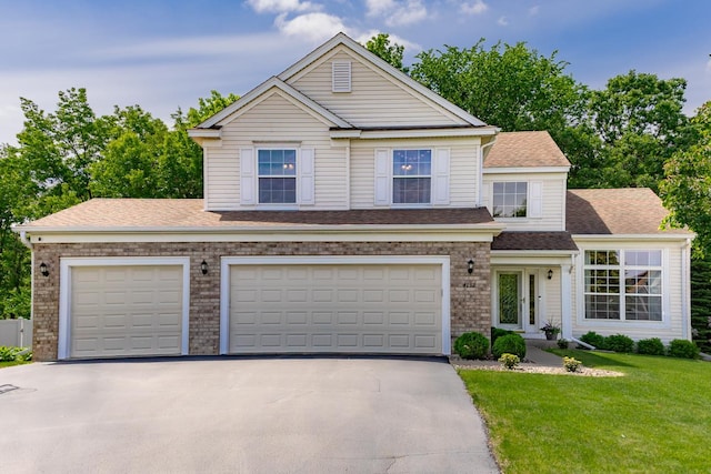 4132 Oakbrooke Curv, Eagan, MN 55122 - traditional home with asphalt driveway, a front lawn, a garage, and roof with shingles