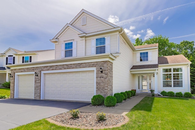 4132 Oakbrooke Curv, Eagan, MN 55122 - traditional-style home with asphalt driveway, an attached garage, a front lawn, and brick siding