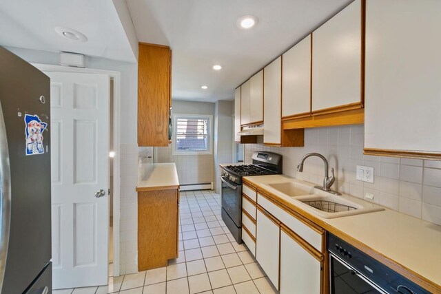 1460 36th St, Minneapolis, MN 55408 - kitchen featuring black appliances, under cabinet range hood, light countertops, a sink, and light tile patterned floors