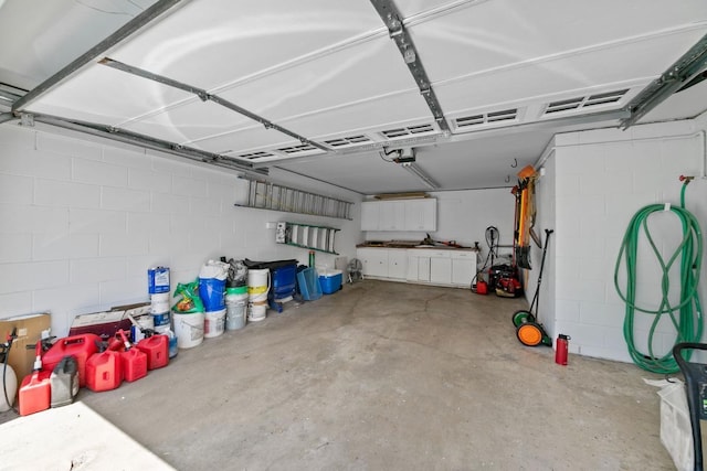 1460 36th St, Minneapolis, MN 55408 - garage with a garage door opener and concrete block wall