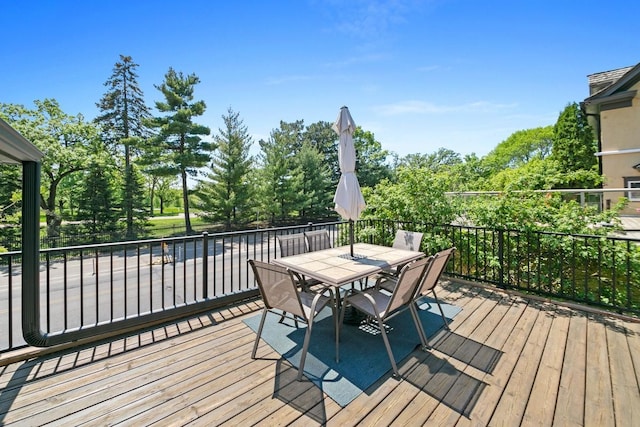 1460 36th St, Minneapolis, MN 55408 - wooden deck with outdoor dining space and view of scattered trees