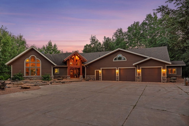 40335 Government Rd, Barry Twp, MN 55037 - view of front of home with stone siding, driveway, an attached garage, and a shingled roof
