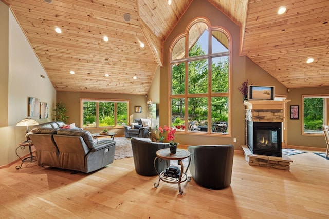 40335 Government Rd, Barry Twp, MN 55037 - living area featuring high vaulted ceiling, wood ceiling, a fireplace, wood finished floors, and plenty of natural light