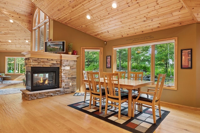 40335 Government Rd, Barry Twp, MN 55037 - dining area featuring lofted ceiling, wooden ceiling, a stone fireplace, wood finished floors, and recessed lighting