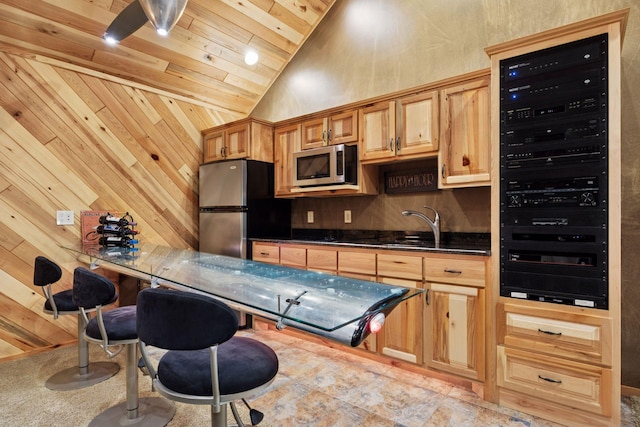40335 Government Rd, Barry Twp, MN 55037 - kitchen featuring appliances with stainless steel finishes, beverage cooler, wooden ceiling, dark countertops, and wood walls
