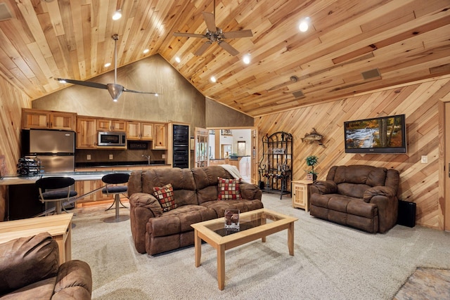 40335 Government Rd, Barry Twp, MN 55037 - living room featuring light colored carpet, high vaulted ceiling, wood ceiling, ceiling fan, and wooden walls