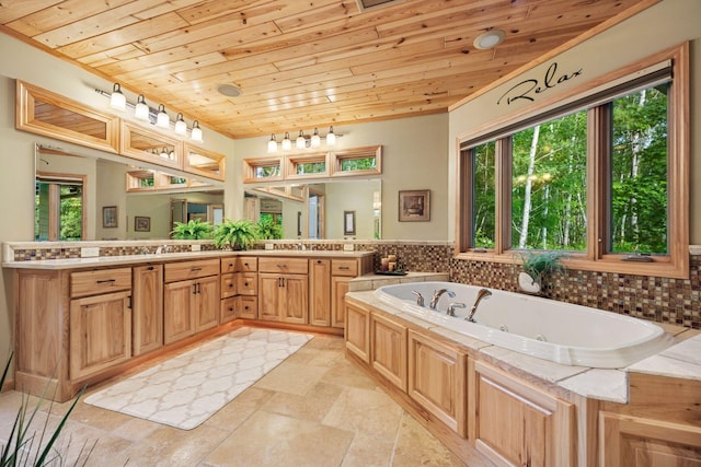 40335 Government Rd, Barry Twp, MN 55037 - full bathroom with wood ceiling, a whirlpool tub, double vanity, and stone tile flooring