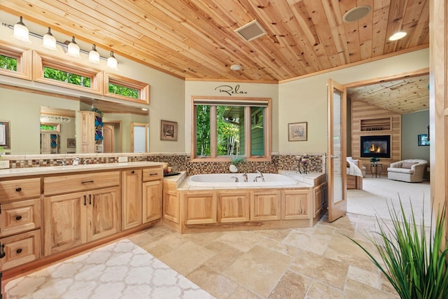 40335 Government Rd, Barry Twp, MN 55037 - full bath with wooden ceiling, a garden tub, vanity, stone tile floors, and ornamental molding