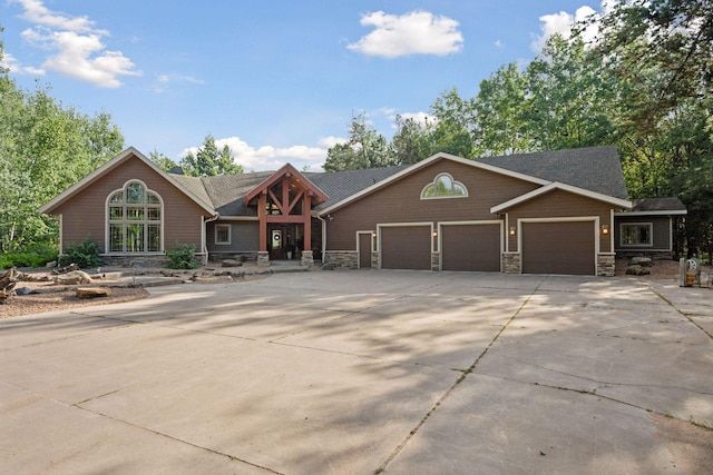 40335 Government Rd, Barry Twp, MN 55037 - view of front of house with stone siding, a garage, and concrete driveway