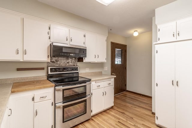 11197 608th Ave, Danville Twp, MN 56068 - kitchen featuring range with two ovens, light countertops, white cabinets, light wood-type flooring, and baseboards