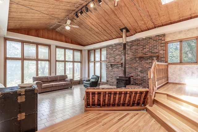 11197 608th Ave, Danville Twp, MN 56068 - living room with wooden ceiling, a wood stove, rail lighting, a ceiling fan, and lofted ceiling