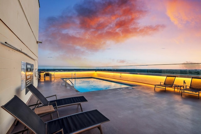400 Groveland Ave Unit 1512, Minneapolis, MN 55403 - pool at dusk featuring an outdoor pool and a patio