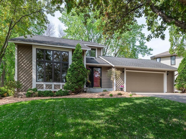 5705 Quinwood Ln N, Plymouth, MN 55442 - view of front facade featuring driveway, an attached garage, and a front yard