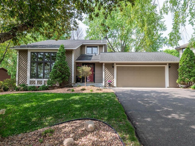 5705 Quinwood Ln N, Plymouth, MN 55442 - view of front of home with a garage, asphalt driveway, a front lawn, and roof with shingles