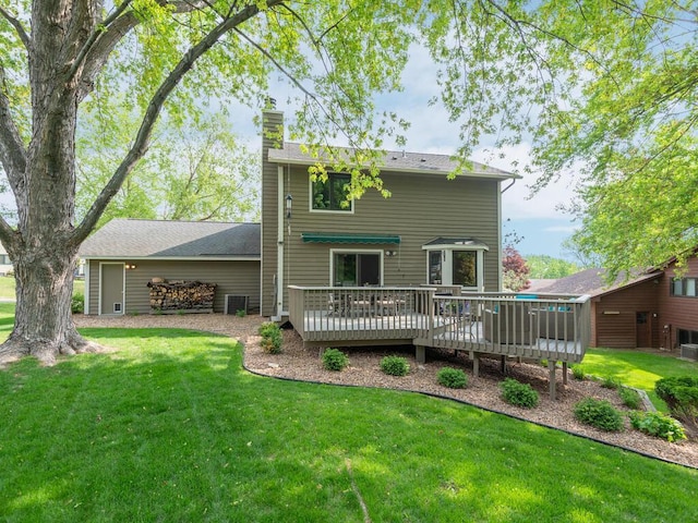 5705 Quinwood Ln N, Plymouth, MN 55442 - rear view of house featuring a deck, a chimney, and a yard